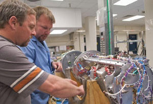John Hickman and Karl Haugh work on sounding rocket